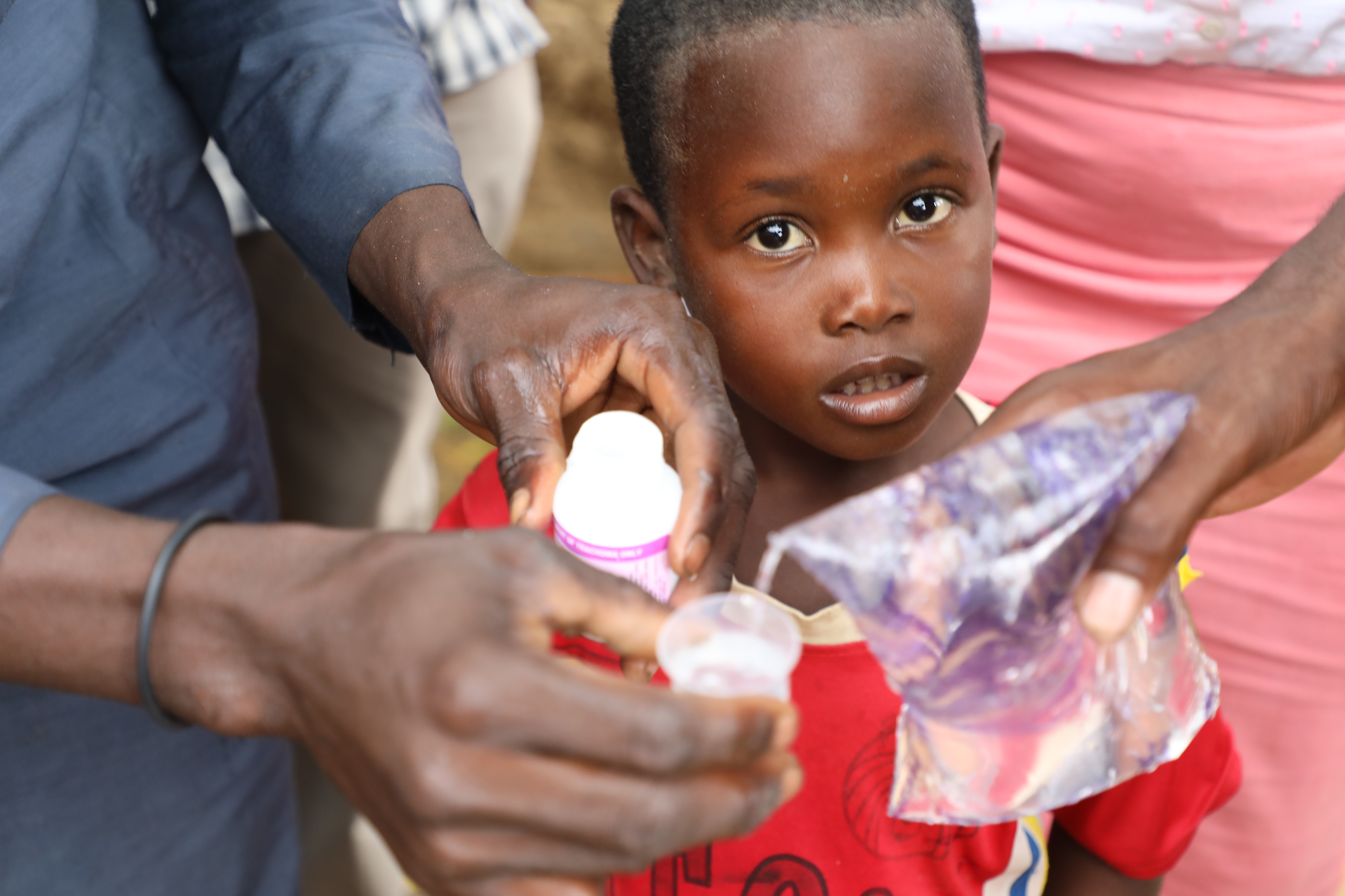 A child waiting to receive his dose of Zithromax® Powder for Oral Suspension (POS) at a Mass Drug Administration (MDA) in Sokoto State, Nigeria. 
